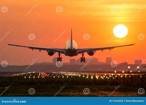 Plane is Landing during Sunrise. Stock Image - Image of dusk, clouds: 71618229