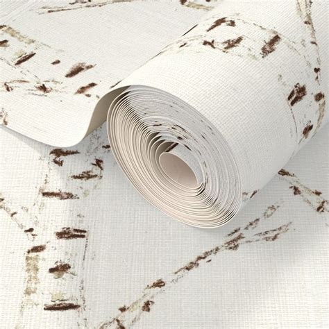 a roll of white wallpaper with brown spots on the paper and it's edge