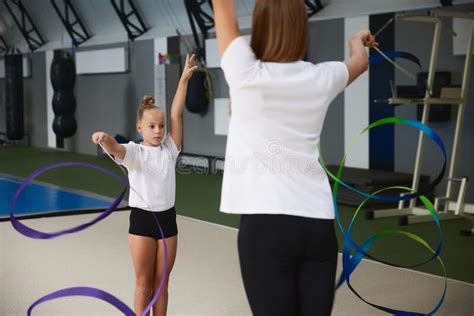 Coaching. Beginner Gymnastics Athletes Doing Exercises with Gymnastics Equipment at Sports Gym ...