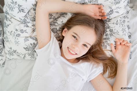 Teen girl lying in bed idle in quarantine - stock photo 2492663 | Crushpixel