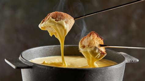 Cheese Fondue Vs. Raclette: What's The Difference?