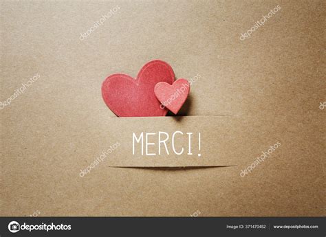 Merci - Thank you in French language with small hearts Stock Photo by ©Melpomene 371470452