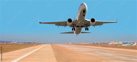 Airplane taking off from the airport Stock Photo | Adobe Stock