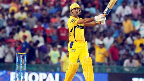 MS Dhoni With Bat Is Wearing Yellow Sports Dress In Blur Crowds Background HD Dhoni Wallpapers ...