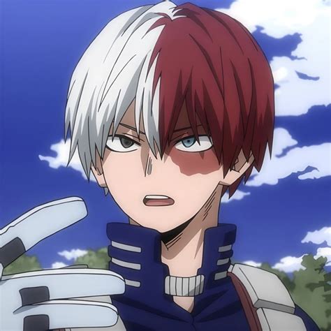 an anime character with red hair and blue eyes holding a white object in his hand