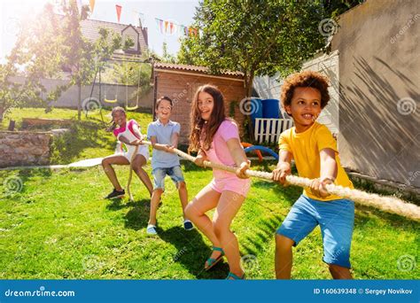 Group Of Kids Play Pulling Rope Game On The Lawn Stock Photo | CartoonDealer.com #160639348