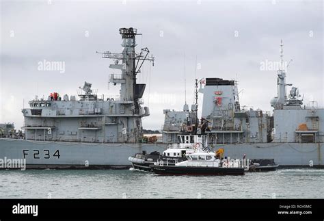 HMS Iron Duke, a Royal Navy Type-23 frigate, is towed out of Portsmouth harbour down to HMNB ...