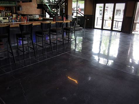 A polished concrete floor with a black stain and white decorative joints provides a beautiful, n ...