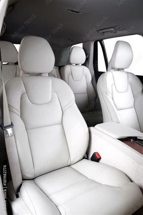 Luxury car inside. Interior of prestige modern car. Comfortable leather seats. White leather ...