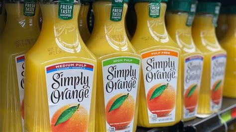 bottles of simply orange juice are on display for sale in a grocery ...