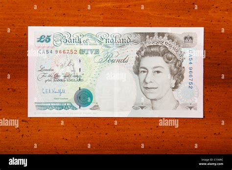 Five pound British currency note on table showing Queen Elizabeth II Stock Photo - Alamy