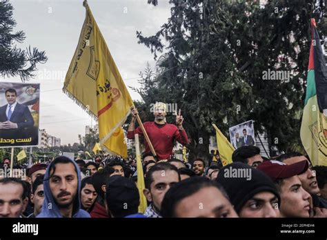 A Palestinian holds a Fatah movement flag during the celebrations ...