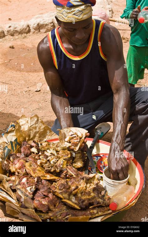 Between Agadez and Niamey; Niger, Street food vendor serving meat by ...