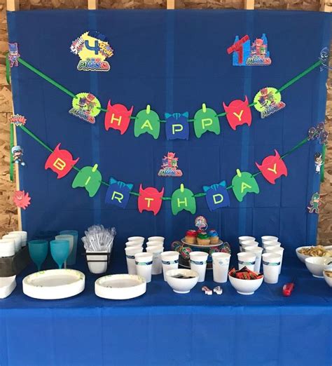 a blue table topped with plates and bowls filled with food next to a ...