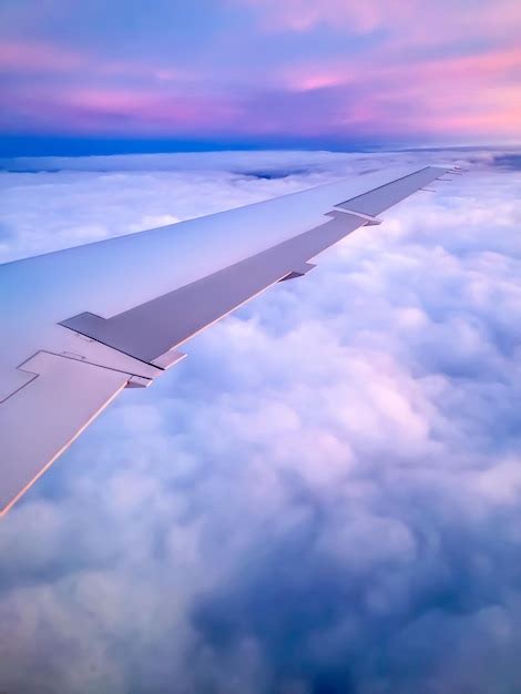 Premium Photo | Airplane wing flying through clouds view from window