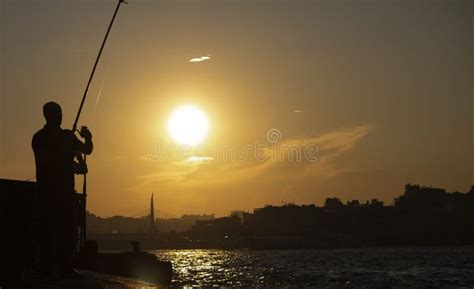 Sunset Silhouette of Holding Fish Stock Image - Image of reflection ...