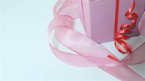 Wrapped with ribbon gift box placed on table · Free Stock Photo