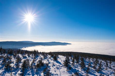 Winter Landscape and Sun with Beams in Blue Sky · Free Stock Photo