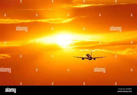 Plane is taking off at sunset Stock Photo - Alamy