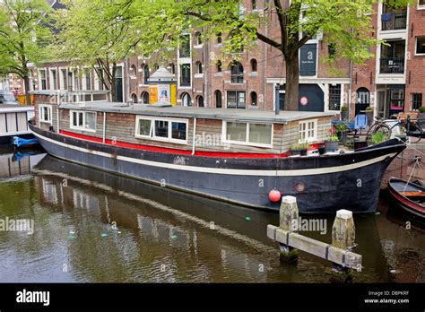 Barge houseboat on a canal in Amsterdam, Netherlands Stock Photo - Alamy