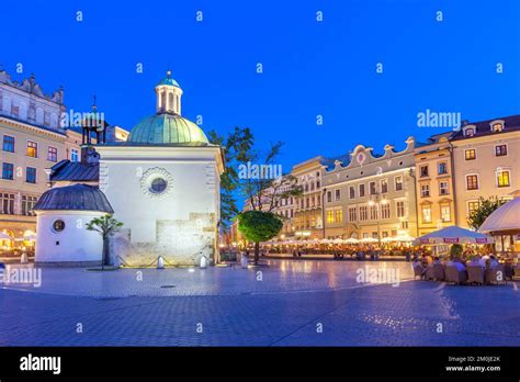 Main Market Square with restaurants and Church of St. Adalbert in downtown Krakow, Poland at ...