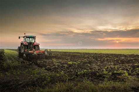 Tractor plowing a field stock image. Image of harrow - 61732327