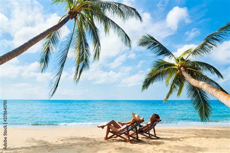 Couple relax on the beach enjoying beautiful sea on the tropical island Stock Photo | Adobe Stock