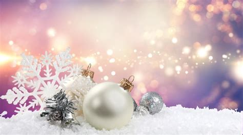 Premium Photo | Silver christmas balls over snow isolated on white