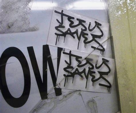 some stickers that are on the side of a door with graffiti written on them