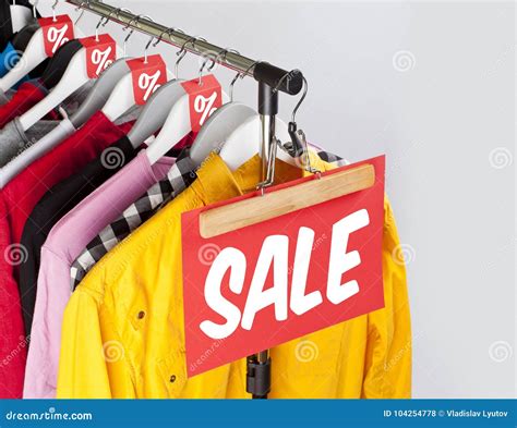 Sale in a Clothing Store - Discount Sign at a Clothes Rack. Stock Photo - Image of apparel ...