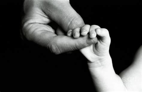 Father holding hand of baby Photograph by Sami Sarkis