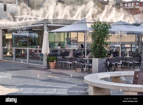 Pula, Croatia. An open-air restaurant using a water mist cooling system in summer, when 40 ...