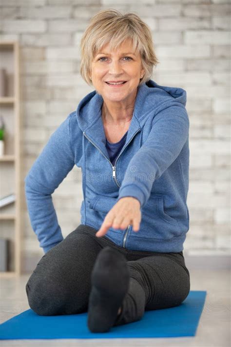 Senior Woman Exercising in Home Gym Stock Image - Image of mature, agile: 197681019