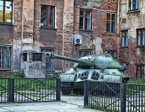 Green Battle Tank Beside the Brick Building · Free Stock Photo