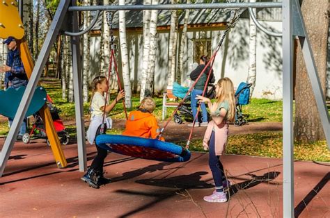 Premium Photo | Children playing on a swing in a park