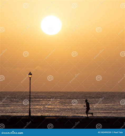 Man Running on Beach Path in Silhouette Stock Image - Image of running, summer: 242499239