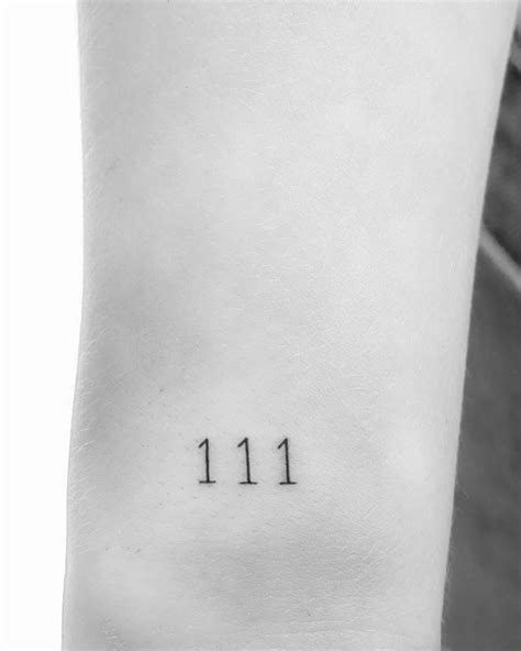 Angel number "111" tattooed on the wrist.