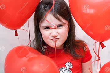 Little Naughty Angry Girl Face Close Up among Red Heart-shaped Balloons ...