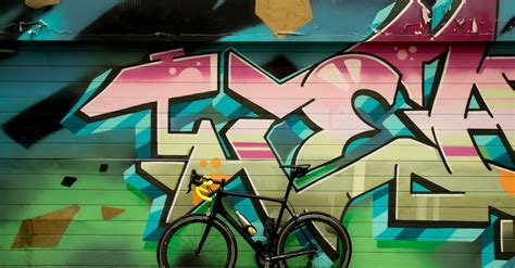 Bicycle Standing Next to a Graffiti Wall · Free Stock Photo