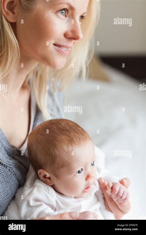 Mother hugging her newborn Stock Photo - Alamy