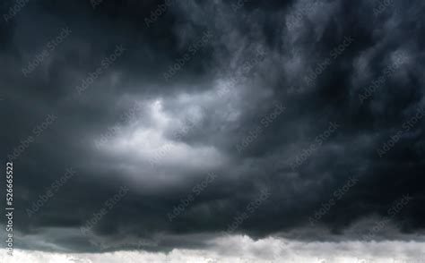 Dramatic dark storm rain clouds black sky background. Dark thunderstorm clouds rainny atmosphere ...