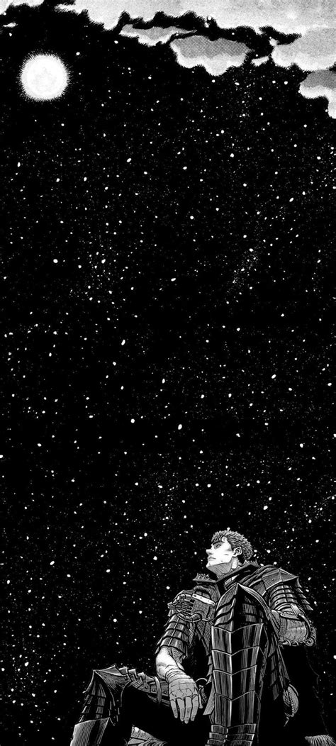 a man sitting on top of a snow covered ground under a sky filled with stars