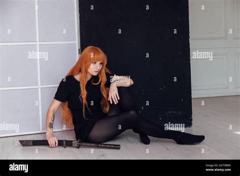 fashionable woman with red hair anime japan sword Stock Photo - Alamy