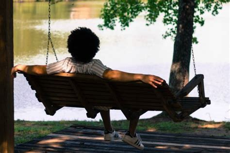 person-relaxing-on-wooden-bench-swing - Positive Routines