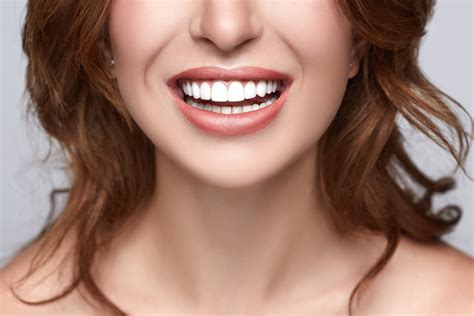 Healthy white smile close up. Beauty woman with perfect smile, lips and teeth. Beautiful Model ...