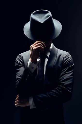 Man In Suit Hiding Face Behind His Hat Isolated On Dark Background Stock Photo - Download Image ...