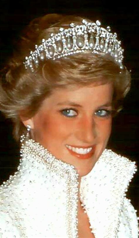 a woman wearing a tiara with pearls on it