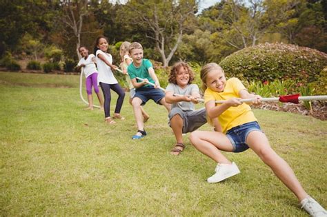 Premium Photo | Children pulling a rope in tug of war