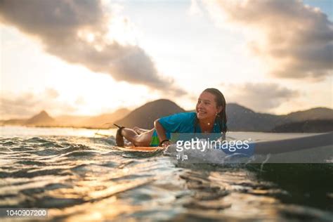 Young Girl Surfing At Sunset High-Res Stock Photo - Getty Images