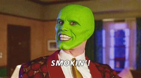 a man wearing a green mask with the words smokiin in front of him